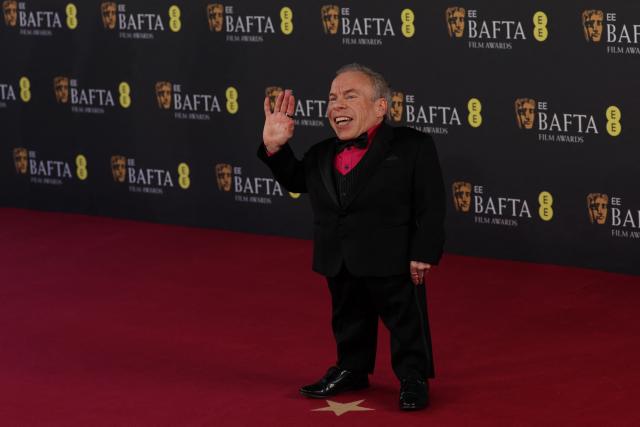 British actor Warwick Davis poses on the red carpet upon arrival at the BAFTA British Academy Film Awards at the Royal Festival Hall, Southbank Centre, in London, on February 22, 2026. (Photo by Adrian Dennis / AFP)