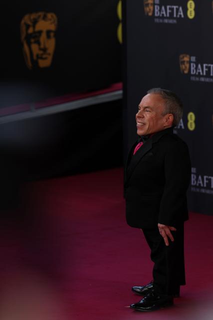 British actor Warwick Davis poses on the red carpet upon arrival at the BAFTA British Academy Film Awards at the Royal Festival Hall, Southbank Centre, in London, on February 22, 2026. (Photo by Adrian Dennis / AFP)
