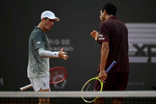 Brazil's Joao Fonseca (L) celebrates with his partner Brazil's Marcelo Melo after winning a point during their men's doubles final match against Netherlands's Robin Haase and Germany's Constantin Frantzen at the Rio Open tennis tournament in Rio de Janeiro, Brazil, on February 22, 2026. (Photo by Mauro PIMENTEL / AFP)