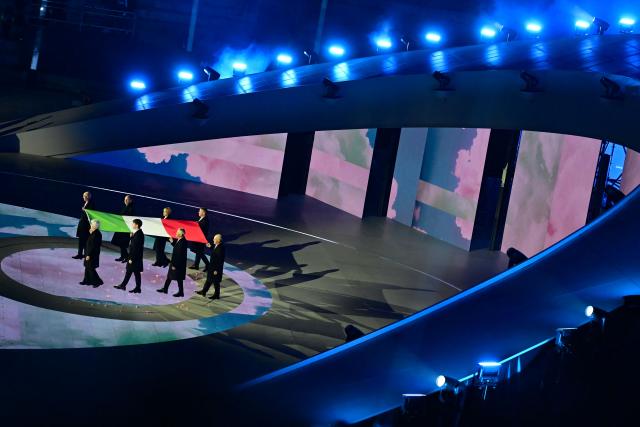 The Italian flag is presented during the closing ceremony of the Milano Cortina 2026 Winter Olympic Games at the Verona Arena in Verona, northern Italy, on February 22, 2026. (Photo by PIERO CRUCIATTI / AFP)