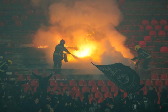 Firefighters extinguish seats set ablaze by Partizan supporters during the Serbian SuperLiga football match between Crvena Zvezda (Red Star) and Partizan Belgrade at the Rajko Mitic Stadium in Belgrade on February 22, 2026. Known as the “Eternal Derby”, the rivalry between the capital’s two biggest clubs dates back to 1947 and is widely considered one of the most intense football rivalries in Europe. (Photo by Pedja MILOSAVLJEVIC / AFP)