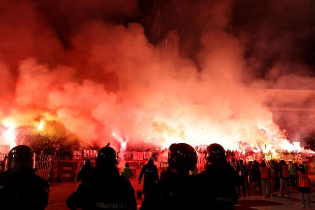Crvena Zvezda supporters celebrate their team’s victory by lighting flares after the Serbian SuperLiga football match between Crvena Zvezda (Red Star) and Partizan Belgrade at the Rajko Mitic Stadium in Belgrade on February 22, 2026. Known as the “Eternal Derby”, the rivalry between the capital’s two biggest clubs dates back to 1947 and is widely considered one of the most intense football rivalries in Europe. (Photo by Pedja MILOSAVLJEVIC / AFP)
