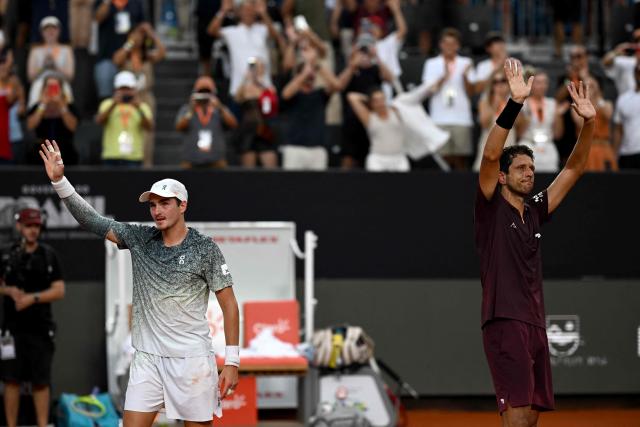 Brazil's Joao Fonseca (L) and his partner Brazil's Marcelo Melo celebrate winning their men's doubles final match against Netherlands's Robin Haase and Germany's Constantin Frantzen at the Rio Open tennis tournament in Rio de Janeiro, Brazil, on February 22, 2026. (Photo by MAURO PIMENTEL / AFP)