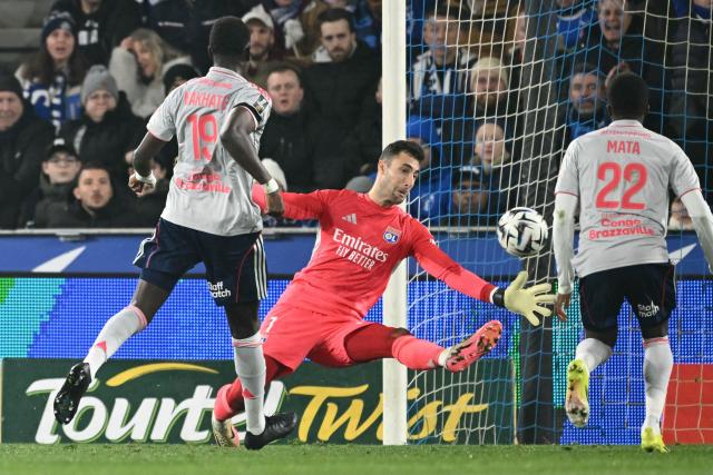 Lyon's Slovak goalkeeper #01 Dominik Greif concedes a goal during the French L1 football match between RC Strasbourg Alsace and Olympique Lyonnais (OL) at the Stade de la Meinau in Strasbourg on February 22, 2026. (Photo by SEBASTIEN BOZON / AFP)