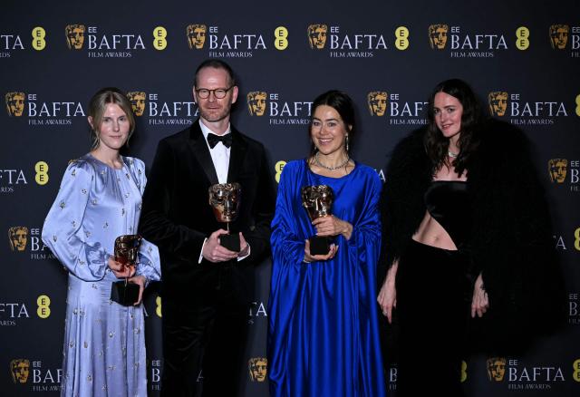 Danish-Norwegian film director Joachim Trier, Norwegian film producer Maria Ekerhovd and Norwegian film producer Andrea Berentsen Ottmar pose with the award for Best film not in English language for "Sentimental Value" during the BAFTA British Academy Film Awards ceremony at the Royal Festival Hall, Southbank Centre, in London, on February 22, 2026. (Photo by JUSTIN TALLIS / AFP)
