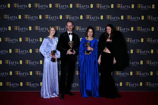 Danish-Norwegian film director Joachim Trier, Norwegian film producer Maria Ekerhovd and Norwegian film producer Andrea Berentsen Ottmar pose with the award for Best film not in English language for "Sentimental Value" during the BAFTA British Academy Film Awards ceremony at the Royal Festival Hall, Southbank Centre, in London, on February 22, 2026. (Photo by JUSTIN TALLIS / AFP)