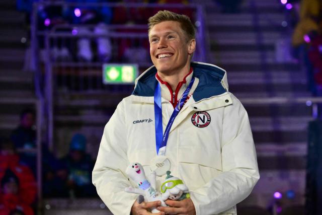 Silver medallist Norway's Martin Loewstroem Nyenget celebrates on the podium for the men's cross country 50km mass start final event of the Milano Cortina 2026 Winter Olympic Games, within the games' closing ceremony at the Verona Arena in Verona on February 22, 2026. (Photo by Stefano RELLANDINI / AFP)