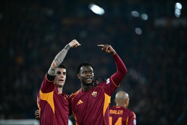 Roma's Ivorian defender #05 Obite Evan Ndicka (R) celebrates scoring his team's second goal during the Italian Serie A football match between AS Roma and Cremonese at the Olympic Stadium in Rome on Febuary 22, 2026. (Photo by Filippo MONTEFORTE / AFP)