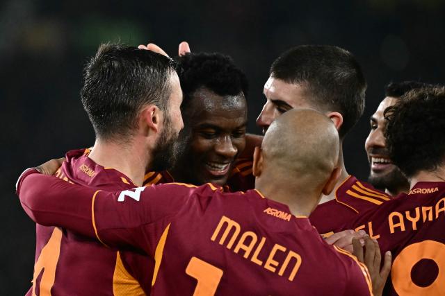 Roma's Ivorian defender #05 Obite Evan Ndicka (2L) celebrates with teammates after scoring his team's second goal during the Italian Serie A football match between AS Roma and Cremonese at the Olympic Stadium in Rome on Febuary 22, 2026. (Photo by Filippo MONTEFORTE / AFP)