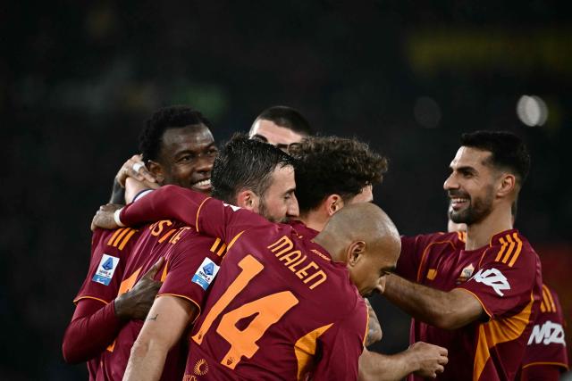 Roma's Ivorian defender #05 Obite Evan Ndicka (L) celebrates with teammates after scoring his team's second goal during the Italian Serie A football match between AS Roma and Cremonese at the Olympic Stadium in Rome on Febuary 22, 2026. (Photo by Filippo MONTEFORTE / AFP)