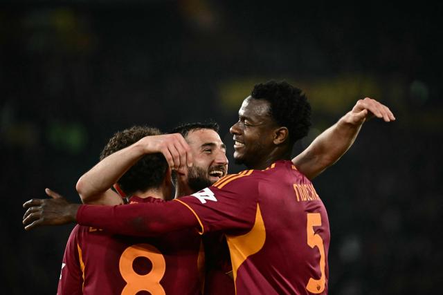 Roma's Ivorian defender #05 Obite Evan Ndicka (R) celebrates with teammates after scoring his team's second goal during the Italian Serie A football match between AS Roma and Cremonese at the Olympic Stadium in Rome on Febuary 22, 2026. (Photo by Filippo MONTEFORTE / AFP)