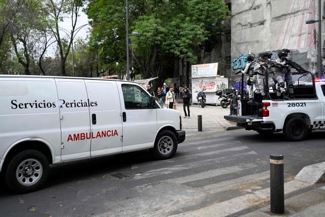 Mexican National Guard special forces escort an ambulance from the forensic service upon its arrival at the Specialized Prosecutor's Office for Organized Crime (FEMDO) headquarters in Mexico City on February 22, 2026. Mexico confirmed on February 22, 2026, that soldiers killed a powerful drug cartel leader who was one of the most wanted men here and in the United States. Nemesio Oseguera, the 59-year-old leader of the violent Jalisco New Generation Cartel, was wounded in a clash with soldiers in the town of Tapalpa and died while being flown to Mexico City, the army said in a statement. (Photo by Alfredo ESTRELLA / AFP)