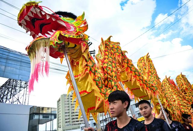 Members of the Chinese community in Panama take part in a parade to celebrate the Chinese New Year, marking the beginning of the Year of the Fire Horse, in Panama City on February 22, 2026. (Photo by Martin BERNETTI / AFP)