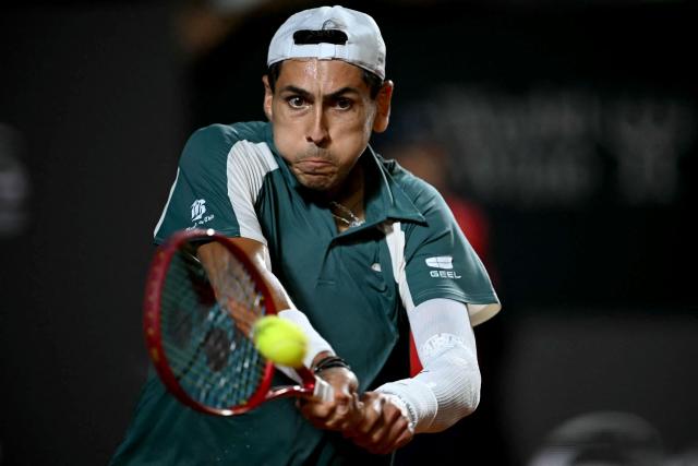 Chile's Alejandro Tabilo hits a return against Argentina's Tomas Etcheverry during their men's singles final match against at the Rio Open tennis tournament in Rio de Janeiro, Brazil, on February 22, 2026. (Photo by Mauro PIMENTEL / AFP)