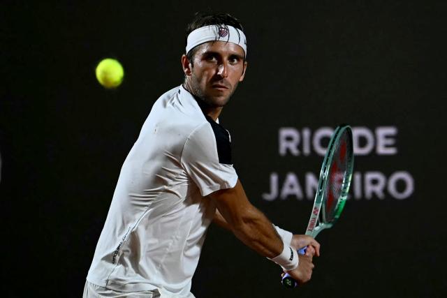 Argentina's Tomas Etcheverry eyes the bal as he plays against Chile's Alejandro Tabilo  during their men's singles final match against at the Rio Open tennis tournament in Rio de Janeiro, Brazil, on February 22, 2026. (Photo by Mauro PIMENTEL / AFP)