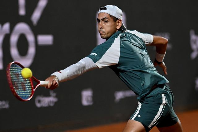 Chile's Alejandro Tabilo hits a return against Argentina's Tomas Etcheverry during their men's singles final match at the Rio Open tennis tournament in Rio de Janeiro, Brazil, on February 22, 2026. (Photo by MAURO PIMENTEL / AFP)