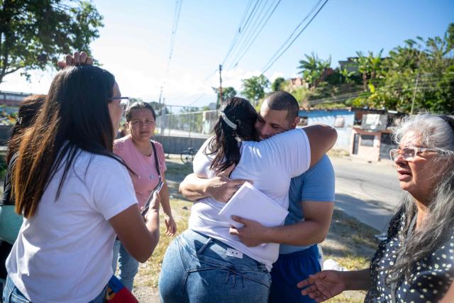 Venezuelan prisoner Jose Damasco greets his relatives after being released from El Rodeo I prison in Guatire, Miranda state, Venezuela on February 22, 2026. More than 200 Venezuelan political prisoners were on hunger strike Sunday to demand their release under a new amnesty law that excludes many of them. The amnesty was approved by Venezuela's congress on February 19, 2026, as part of a wave of reforms encouraged by the United States after it ousted and captured former president Nicolas Maduro on January 3. (Photo by Maryorin Mendez / AFP)
