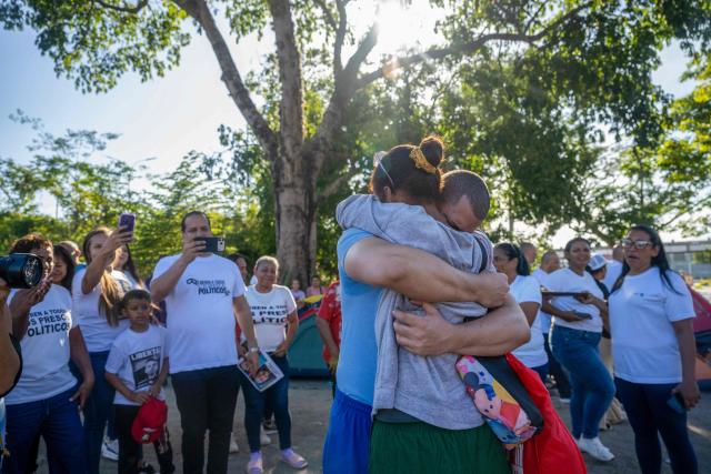 Venezuelan prisoner Jose Damasco greets his relatives after being released from El Rodeo I prison in Guatire, Miranda state, Venezuela on February 22, 2026. More than 200 Venezuelan political prisoners were on hunger strike Sunday to demand their release under a new amnesty law that excludes many of them. The amnesty was approved by Venezuela's congress on February 19, 2026, as part of a wave of reforms encouraged by the United States after it ousted and captured former president Nicolas Maduro on January 3. (Photo by Maryorin Mendez / AFP)