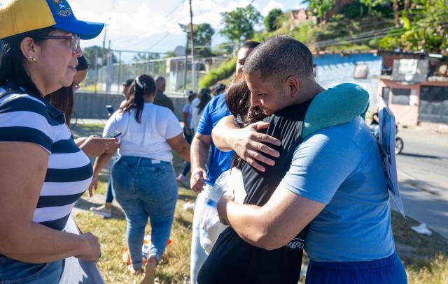 Venezuelan prisoner Jose Damasco (R) greets his relatives after being released from El Rodeo I prison in Guatire, Miranda state, Venezuela on February 22, 2026. More than 200 Venezuelan political prisoners were on hunger strike Sunday to demand their release under a new amnesty law that excludes many of them. The amnesty was approved by Venezuela's congress on February 19, 2026, as part of a wave of reforms encouraged by the United States after it ousted and captured former president Nicolas Maduro on January 3. (Photo by Maryorin Mendez / AFP)