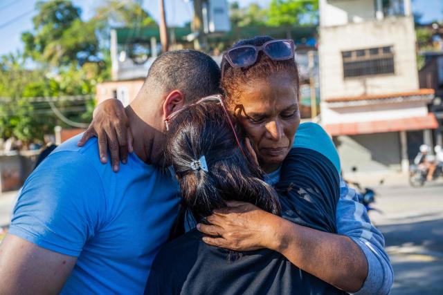 Venezuelan prisoner Jose Damasco (L) greets his relatives after being released from El Rodeo I prison in Guatire, Miranda state, Venezuela on February 22, 2026. More than 200 Venezuelan political prisoners were on hunger strike Sunday to demand their release under a new amnesty law that excludes many of them. The amnesty was approved by Venezuela's congress on February 19, 2026, as part of a wave of reforms encouraged by the United States after it ousted and captured former president Nicolas Maduro on January 3. (Photo by Maryorin Mendez / AFP)