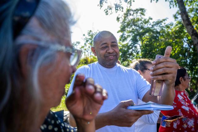 Armando Fusil looks at a mobile phone screen after being released from El Rodeo I prison in Guatire, Miranda State, Venezuela, on February 22, 2026. More than 200 Venezuelan political prisoners were on hunger strike Sunday to demand their release under a new amnesty law that excludes many of them. The amnesty was approved by Venezuela's congress on February 19, 2026, as part of a wave of reforms encouraged by the United States after it ousted and captured former president Nicolas Maduro on January 3. (Photo by Maryorin Mendez / AFP)