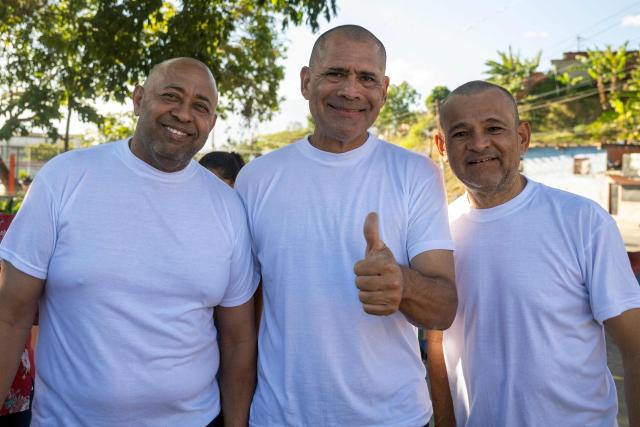 (L to R) Armando Fusil, Richard Corona and Robin Colina pose for a picture after being released from El Rodeo I prison in Guatire, Miranda State, Venezuela, on February 22, 2026. More than 200 Venezuelan political prisoners were on hunger strike Sunday to demand their release under a new amnesty law that excludes many of them. The amnesty was approved by Venezuela's congress on February 19, 2026, as part of a wave of reforms encouraged by the United States after it ousted and captured former president Nicolas Maduro on January 3. (Photo by Maryorin Mendez / AFP)