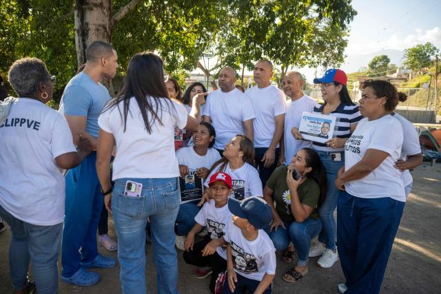 Jose Damasco (2-L) speaks with Armando Fusil (C), Richard Corona (4-R) and Robin Colina (3-R) after all of were released from El Rodeo I prison in Guatire, Miranda State, Venezuela, on February 22, 2026. More than 200 Venezuelan political prisoners were on hunger strike Sunday to demand their release under a new amnesty law that excludes many of them. The amnesty was approved by Venezuela's congress on February 19, 2026, as part of a wave of reforms encouraged by the United States after it ousted and captured former president Nicolas Maduro on January 3. (Photo by Maryorin Mendez / AFP)