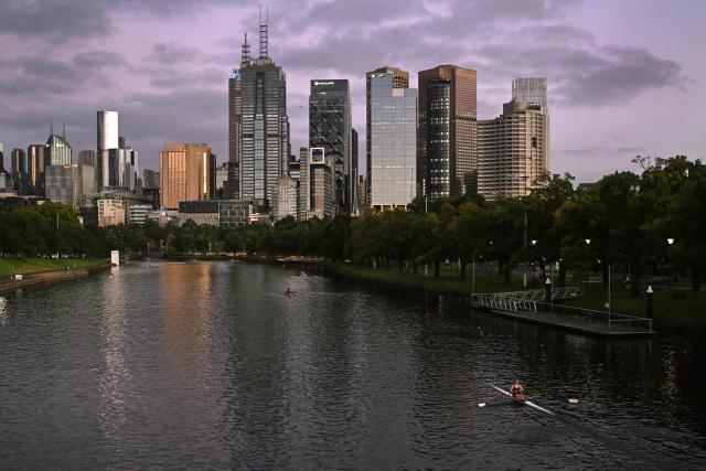 A single sculler rows along the Yarra River towards the Melbourne central business district during an early morning training session on February 23, 2026. (Photo by William WEST / AFP)