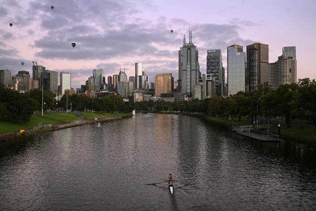 A single sculler rows along the Yarra River towards the Melbourne central business district during an early morning training session on February 23, 2026. (Photo by William WEST / AFP)