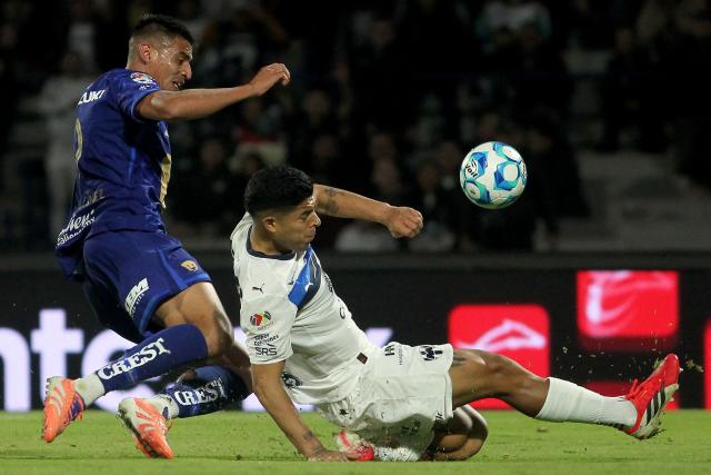 Pumas' forward #09 Guillermo Martinez (L) and Monterrey's defender #04 Victor Guzman fight for the ball during the Liga MX Clausura match between Pumas and Monterrey at Olimpico Universitario Stadium in Mexico City on February 22, 2026. (Photo by Victor Cruz / AFP)