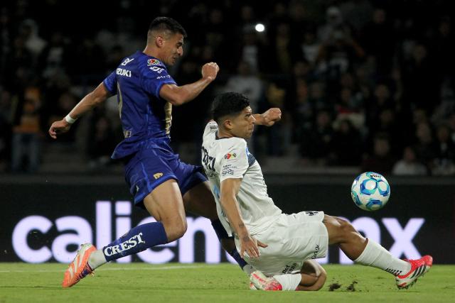 Pumas' forward #09 Guillermo Martinez (L) and Monterrey's defender #04 Victor Guzman fight for the ball during the Liga MX Clausura match between Pumas and Monterrey at Olimpico Universitario Stadium in Mexico City on February 22, 2026. (Photo by Victor Cruz / AFP)