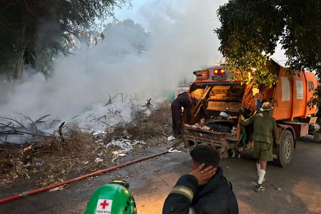 Smoke rises from a fire at an open-air garbage dumping site in a neighborhood of Havana, on February 22, 2026.  (Photo by Yamil LAGE / AFP)