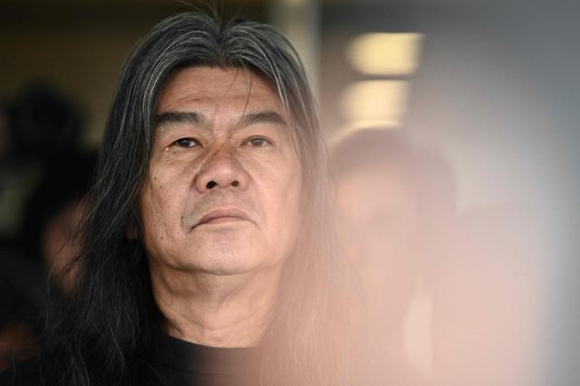 (FILES) Ousted pro-democracy lawmaker Leung Kwok-hung (C), also known as 'Long Hair' reacts before entering the High Court to hear the sentence for his appeal over his disqualification from Legco in Hong Kong on February 15, 2019. Hong Kong's Court of Appeal upheld the jailing of 12 democracy campaigners on February 23, 2026 as part of a high-profile subversion case under a Beijing-imposed national security law. (Photo by Anthony WALLACE / AFP)