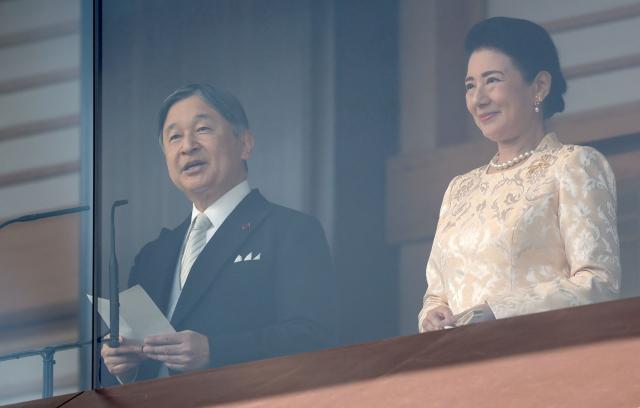 Japan's Emperor Naruhito (L), accompanied by Empress Masako (R), delivers a speech at a public audience celebrating his 66th birthday at the Imperial Palace in Tokyo on February 23, 2026. (Photo by JIJI PRESS / AFP) / Japan OUT