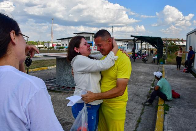 Venezuelan prisoner Jose Gregorio Prieto greets his relatives after being released from Centro de Formacion Hombre Nuevo El Libertador prison in Tocuyito, Venezuela on February 22, 2026. More than 200 Venezuelan political prisoners were on hunger strike on February 22 to demand their release under a new amnesty law that excludes many of them. The amnesty was approved by Venezuela's congress on February 19, as part of a wave of reforms encouraged by the United States after it ousted and captured former president Nicolas Maduro on January 3. (Photo by Gabriela ALDAZORO / AFP)