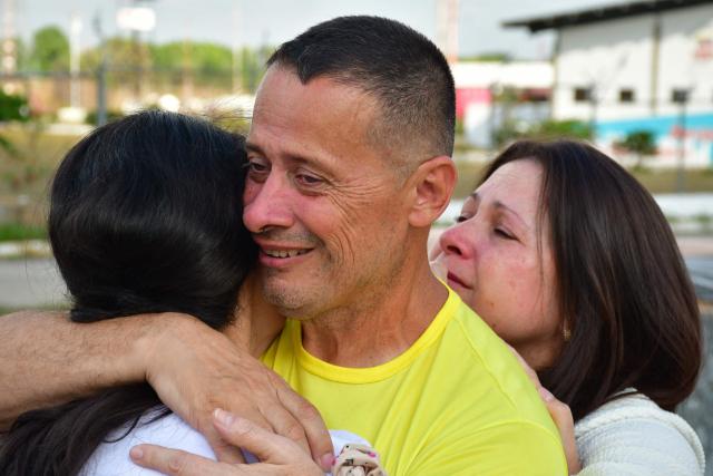 Venezuelan prisoner Jose Gregorio Prieto greets his relatives after being released from Centro de Formacion Hombre Nuevo El Libertador prison in Tocuyito, Venezuela on February 22, 2026. More than 200 Venezuelan political prisoners were on hunger strike on February 22 to demand their release under a new amnesty law that excludes many of them. The amnesty was approved by Venezuela's congress on February 19, as part of a wave of reforms encouraged by the United States after it ousted and captured former president Nicolas Maduro on January 3. (Photo by Gabriela ALDAZORO / AFP)