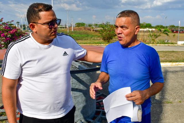 Venezuelan prisoner Hostaris Socorro Molina Pinto (R) greets his relatives after being released from Centro de Formacion Hombre Nuevo El Libertador prison in Tocuyito, Venezuela on February 22, 2026. More than 200 Venezuelan political prisoners were on hunger strike on February 22 to demand their release under a new amnesty law that excludes many of them. The amnesty was approved by Venezuela's congress on February 19, as part of a wave of reforms encouraged by the United States after it ousted and captured former president Nicolas Maduro on January 3. (Photo by Gabriela ALDAZORO / AFP)