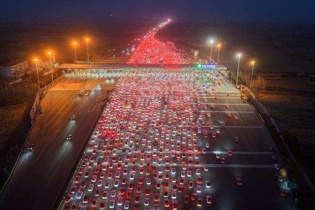 Drivers merge onto expressway lanes after passing through the Wuzhuang toll station in Chuzhou, eastern China's Anhui Province on February 22, 2026, at the end of the Spring Festival holiday marking the Year of the Horse. (Photo by CN-STR / AFP) / China OUT