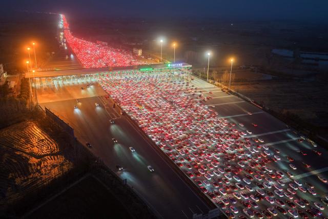 Drivers merge onto expressway lanes after passing through the Wuzhuang toll station in Chuzhou, eastern China's Anhui Province on February 22, 2026, at the end of the Spring Festival holiday marking the Year of the Horse. (Photo by CN-STR / AFP) / China OUT