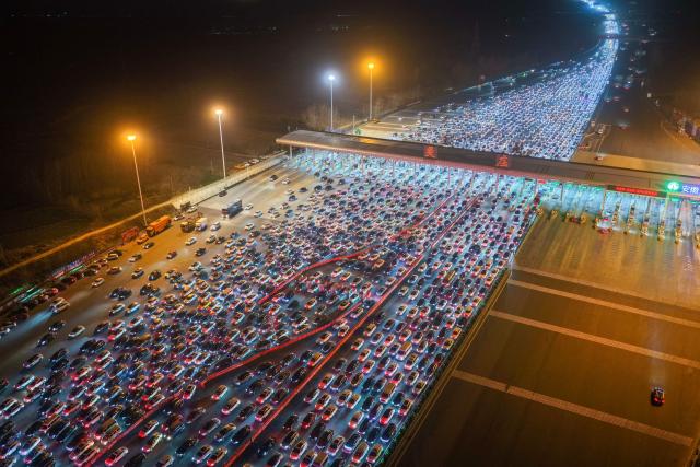 Drivers merge onto expressway lanes after passing through the Wuzhuang toll station in Chuzhou, eastern China's Anhui Province on February 22, 2026, at the end of the Spring Festival holiday marking the Year of the Horse. (Photo by CN-STR / AFP) / China OUT