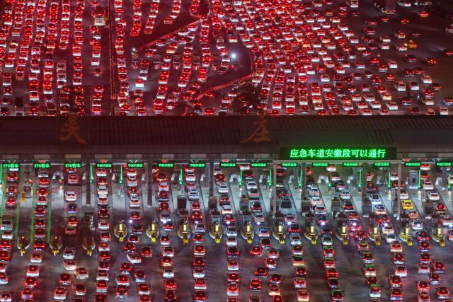 Drivers merge onto expressway lanes after passing through the Wuzhuang toll station in Chuzhou, eastern China's Anhui Province on February 22, 2026, at the end of the Spring Festival holiday marking the Year of the Horse. (Photo by CN-STR / AFP) / China OUT