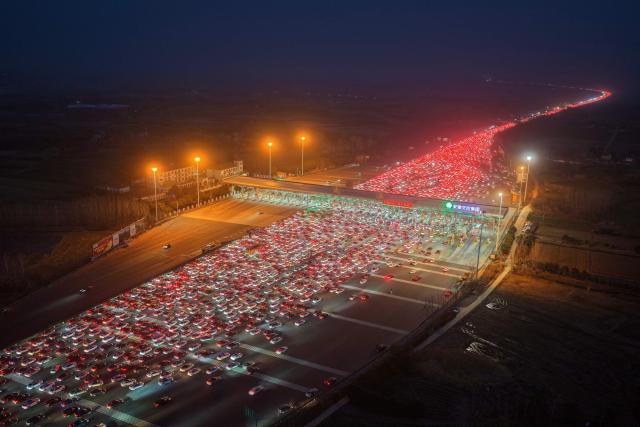 Drivers merge onto expressway lanes after passing through the Wuzhuang toll station in Chuzhou, eastern China's Anhui Province on February 22, 2026, at the end of the Spring Festival holiday marking the Year of the Horse. (Photo by CN-STR / AFP) / China OUT