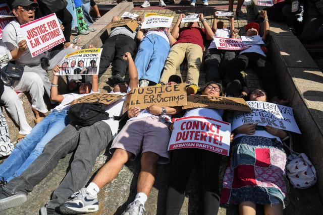 Activists and supporters of families of the victims of extrajudicial killings of former Philippine president Rodrigo Duterte's drug war take part in a protest in Manila on February 23, 2026. A hearing begins at the International Criminal Court (ICC) on February 23 that will determine whether Duterte will stand trial over at least 76 of those deaths. (Photo by Ted ALJIBE / AFP)