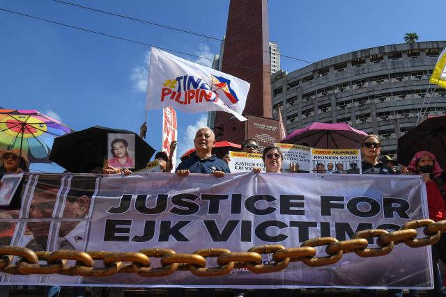 Activists and supporters of families of the victims of extrajudicial killings of former Philippine president Rodrigo Duterte's drug war take part in a protest in Manila on February 23, 2026. A hearing begins at the International Criminal Court (ICC) on February 23 that will determine whether Duterte will stand trial over at least 76 of those deaths. (Photo by Ted ALJIBE / AFP)