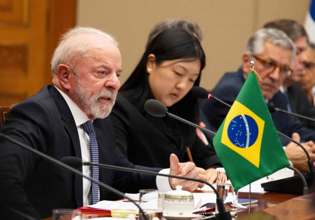 Brazil's President Luiz Inacio Lula da Silva (L) talks with South Korea's President Lee Jae Myung (not pictured) during their meeting at the presidential Blue House in Seoul on February 23, 2026. Brazilians could more easily get their hands on coveted "K-beauty" products under a deal struck on February 23 during President Luiz Inacio Lula da Silva's state visit to South Korea. Lula and South Korean leader Lee Jae Myung signed a slew of agreements with the Brazilian president in Seoul, covering everything from agriculture to business cooperation. (Photo by JEON HEON-KYUN / POOL / AFP)