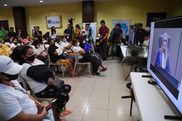 Families of victims in extrajudicial killings of former Philippine president Rodrigo Duterte's drug war watch a live stream of Duterte's confirmation hearing from The Hague, at the Paghilom office in Manila on February 23, 2026. The International Criminal Court opened hearings February 23 to decide whether former Philippine president Rodrigo Duterte should stand trial for crimes against humanity linked to his deadly anti-drug crackdown. (Photo by TED ALJIBE / AFP)