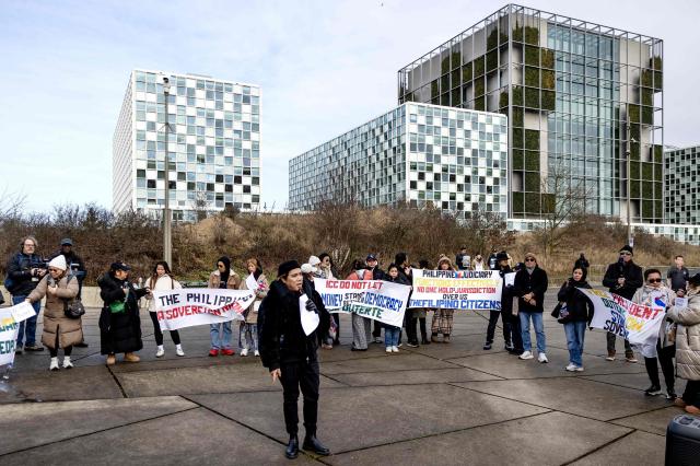 People demonstrate in support of former Philippines' president Rodrigo Duterte outside the International Criminal Court (ICC) where he will be questioned on charges of crimes against humanity, in The Hague on February 23, 2026. As the 80-year-old will not be present at the hearing after the court granted a defence request to waive his right to appear, despite judges ruling that he was fit to take part, the "confirmation of charges" hearing, taking place over four days, will determine whether there is enough evidence against Duterte to proceed to a trial. (Photo by Ramon van Flymen / ANP / AFP) / Netherlands OUT