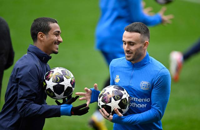 Bayer Leverkusen's Brazilian defender #13 Arthur (L) and Bayer Leverkusen's Spanish midfielder #24 Aleix Garcia attend a training session on February 23, 2026 in Leverkusen, western Germany, on the eve of the UEFA Champions League - Knockout round play-off - Second Leg football match of Bayer Leverkusen (GER) v Olympiakos (GRE). (Photo by INA FASSBENDER / AFP)