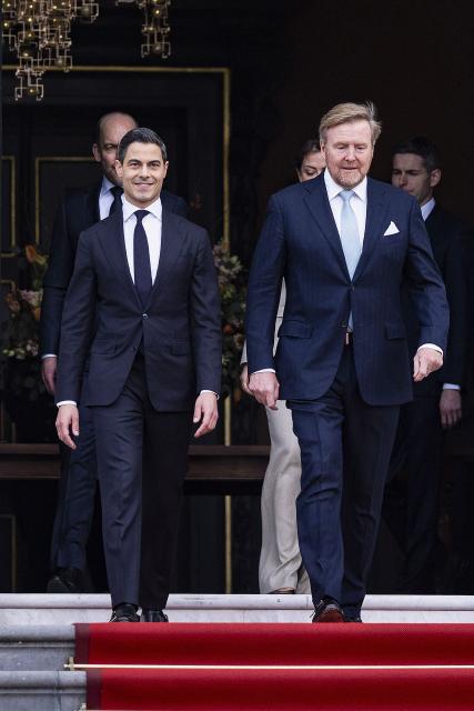 Netherlands' new Prime minister Rob Jetten (L) and Netherlands' Willem-Alexander (L) appear on the top of the steps ahead of the family photograph as part of the swearing-in ceremony of the new Jetten cabinet at Huis ten Bosch Palace in The Hague, The Netherlands on February 23, 2026. The new Dutch government will be sworn in today, with 38-year-old centrist Rob Jetten set to be the country's youngest-ever prime minister. (Photo by Jeroen Jumelet / ANP / AFP) / Netherlands OUT