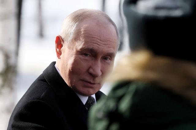 Russia's President Vladimir Putin leaves after a wreath-laying ceremony at the Tomb of the Unknown Soldier by the Kremlin Wall to mark Defender of the Fatherland Day in Moscow on February 23, 2026. (Photo by Maxim SHIPENKOV / POOL / AFP)